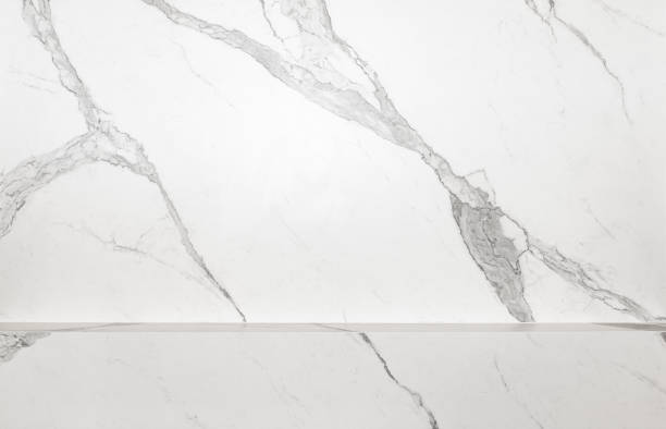 istock White marble texture background with a countertop to place items on 2175181279