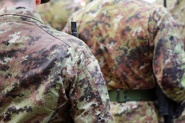 istock many soldiers standing at attention wearing camouflage uniforms 2175181478