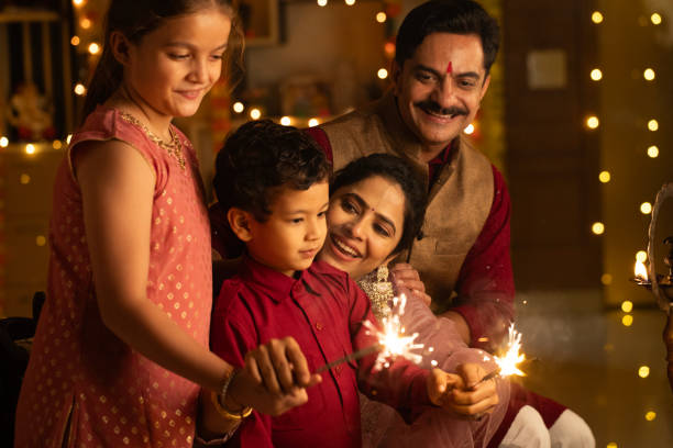istock Parents with children burning sparklers at home during Diwali 2175187532