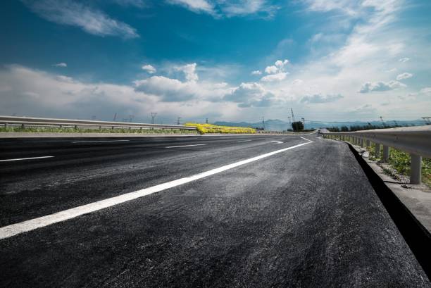 istock New asphalt road through the countryside 2175187890