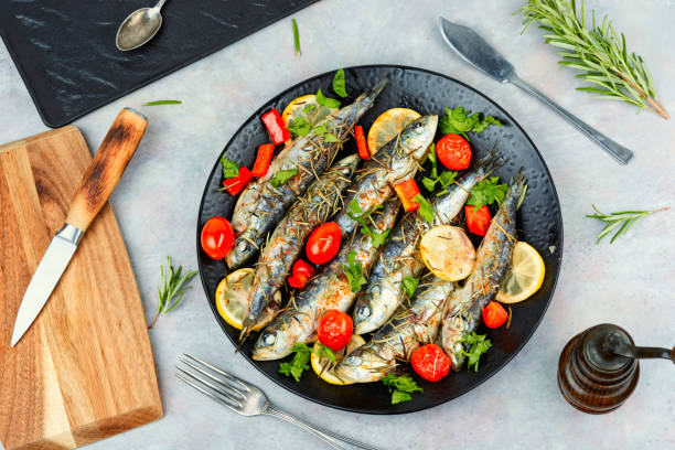 istock Whole roasted fish with lemon slices and herbs. 2175190331