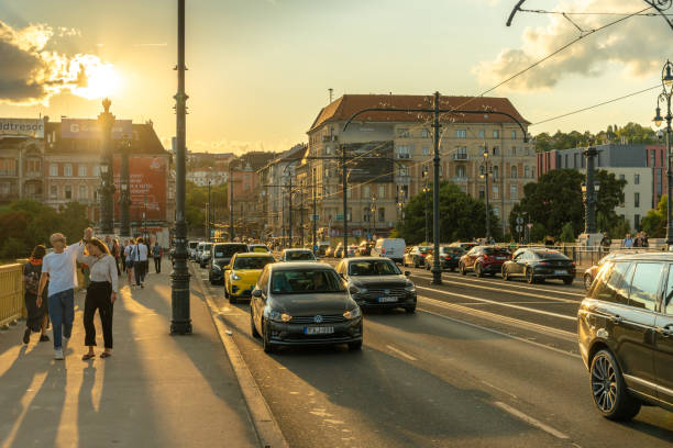 Budapest, Hungary - September 19, 2024: Golden Hour on Margit Bridge: A Peaceful Evening Walk with Smiling Faces and a Sunset View.