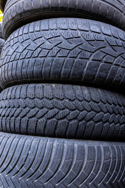 istock Stack of old, worn and damaged tires lying in a landfill. 2175194904