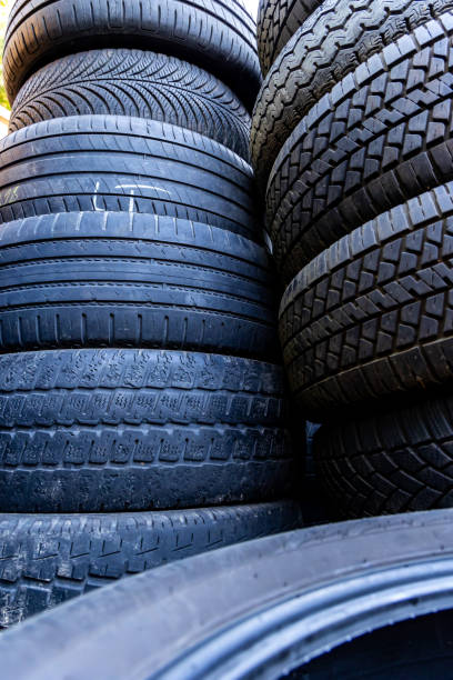 istock Stack of old, worn and damaged tires lying in a landfill. 2175194949