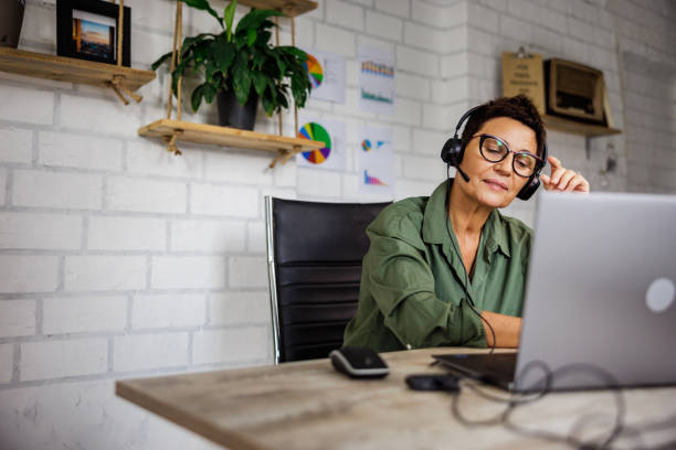 istock Beautiful senior woman have video call while working in home office 2175199564