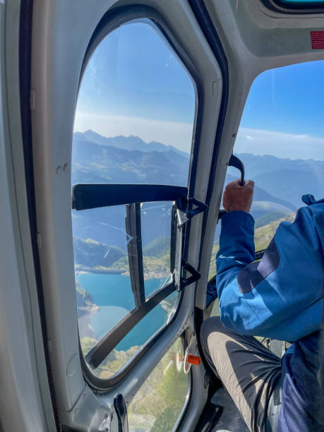 istock Tourist enjoying flying on helicopter over the Alps 2175202673
