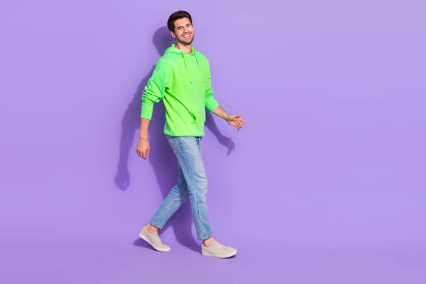 istock Full length photo of cool funny guy dressed neon sweatshirt walking empty space isolated violet color background 2175203691