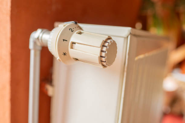 radiator, checking indoor temperature and ensuring comfortable living environment, personal comfort, heating season, Creating cozy haven