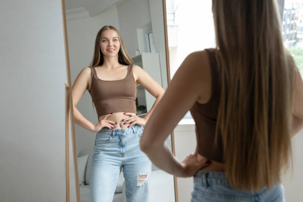 istock Confident and smiling woman looking at mirror 2175206546
