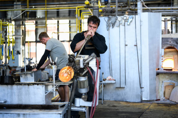 Karlovy Vary, Czech Republic - August 12 2024: Glass Blower or Gaffer blowing a Glass in the Moser Factory.