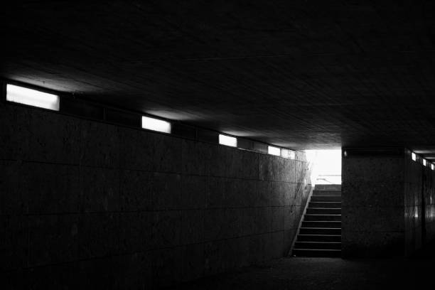 istock Dimly Lit Passageway with Stairs to Daylight 2175212749