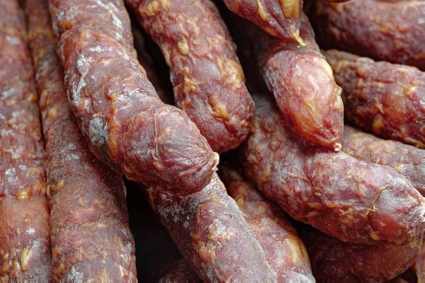 Group of smoked pork sausages, close up shot, abstract food background