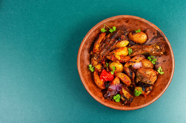 Spare ribs or grilled ribs with stewed vegetables. Barbecue ribs in rustic bowl. Copy space.