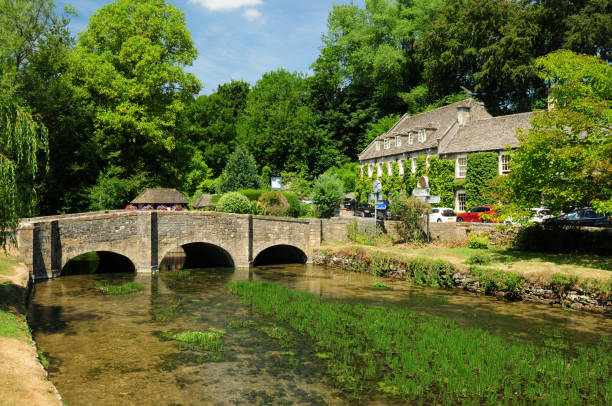Idyllic Coln River In Bibury Cotswolds England Great Britain On A Beautiful Summer Day