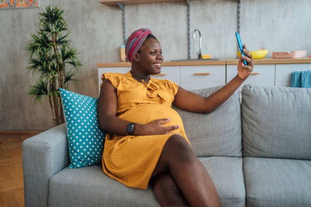 istock Pregnant woman taking selfies at home 2175235630