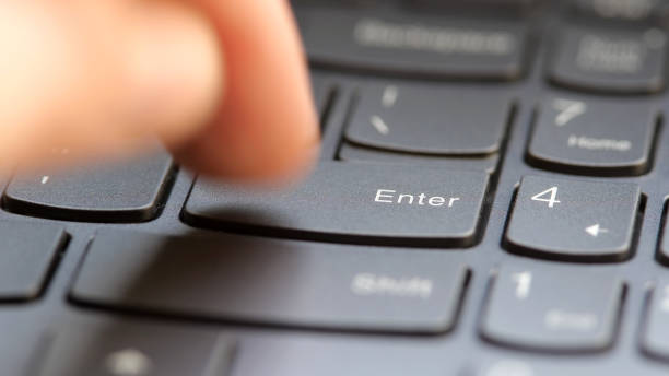 istock Man quickly pressing the enter key on a modern laptop computer keyboard, macro detail extreme closeup, shallow DOF, one person. Sending a message, buying, accepting rules, running a program concept 2175239726