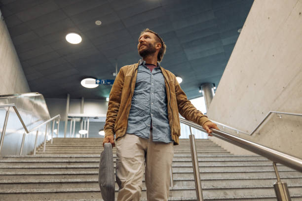 istock Businessman in a train station walking down a staircase 2175242651