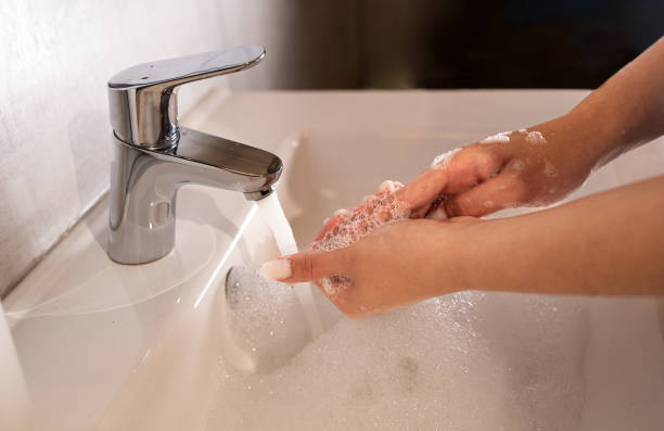 istock Hand washing.  Women's hands wash their hands with soap under running water. 2175246698