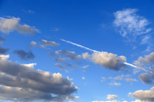 The white cloud trail left by the passenger plane in the sky