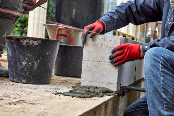 istock construction worker laying a wall of foam blocks 2175251470