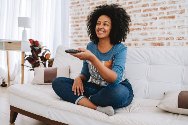 istock Happy woman watching tv 2175259338