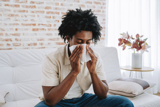 istock Man sneezing with handkerchief on nose 2175259621