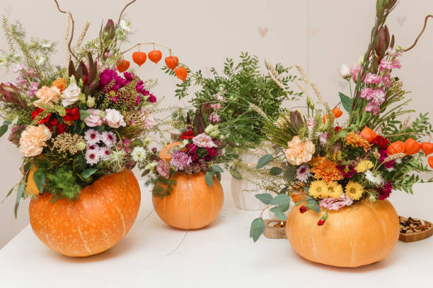 istock Flower arrangement in a pumpkin, autumn interior decor. Creating handmade autumn decor. 2175268565