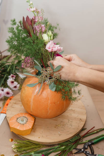 istock Creating a floral composition in a pumpkin. Making decor with your own hands. 2175268649