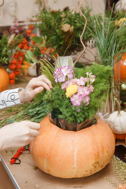 istock Creating a floral composition in a pumpkin. Making decor with your own hands. 2175268873