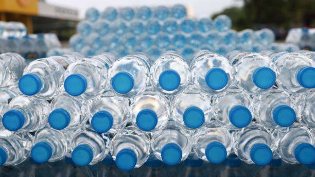 Stack of Drinking Water Bottles. Blue Water Texture with Droplets and Frosty Winter Patterns in the bottom and cover front view