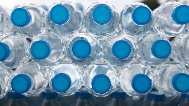 istock Stack of Drinking Water Bottles. Blue Water Texture with Droplets and Frosty Winter Patterns in the bottom and cover front view 2175286443
