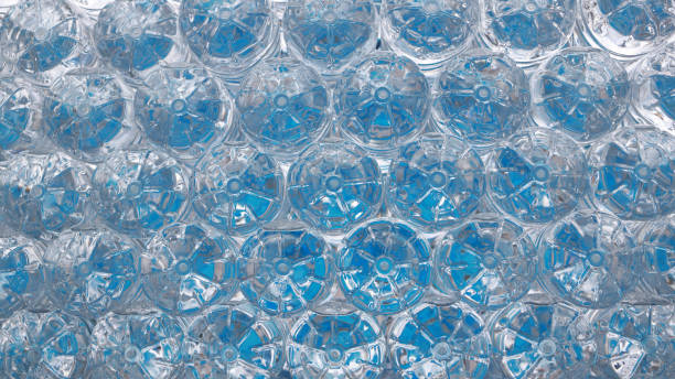 istock Stack of Drinking Water Bottles. Blue Water Texture with Droplets and Frosty Winter Patterns in the bottom and cover front view 2175286465
