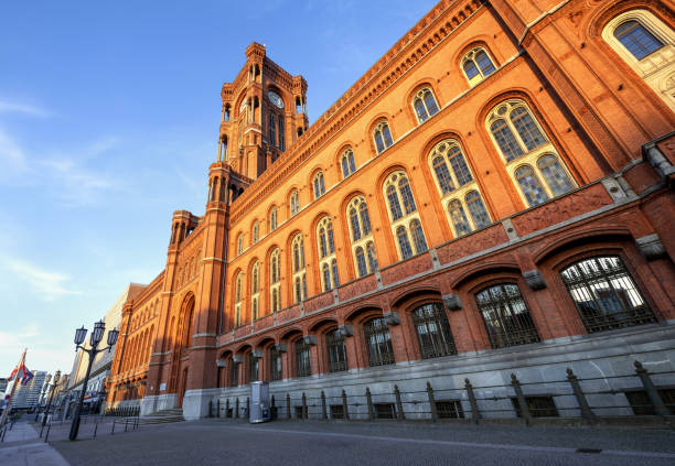 Berlin, Germany, July 5, 2024: Low angle view of the Red Town Hall in Berlin illuminated by setting sun.