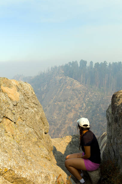 Girl looking at Sequoia National Park covered in smog.