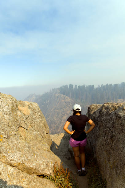 Girl looking at Sequoia National Park covered in smog.