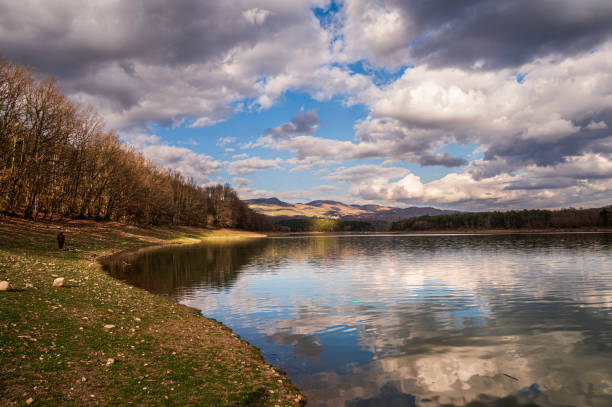 nature sceneries around the lake pertusillo coastline with a cloudy sky in the background