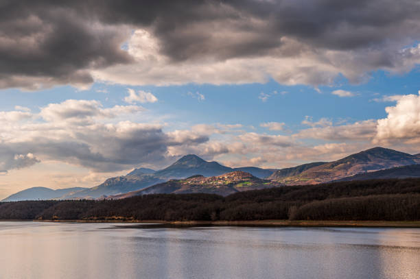 nature sceneries around the lake pertusillo coastline with a cloudy sky in the background
