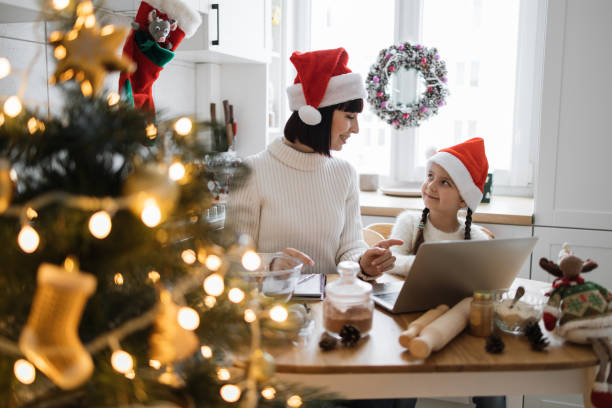 istock Mother and daughter baking cookies in festive kitchen during Christmas 2175297220