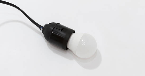 istock Black plastic light socket with white LED bulb attached to black cord on white background. 2175297235