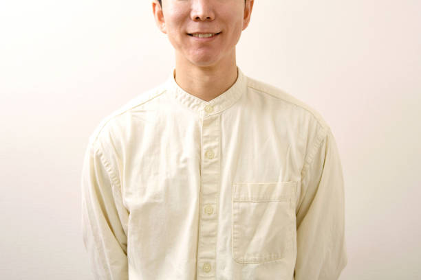 Smiling young Asian man in casual clothes looking at camera