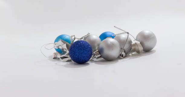 istock Blue and silver Christmas ornaments scattered on plain surface, perfect for holiday themed projects and decor. 2175299033