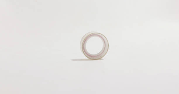 istock Clear, minimalistic image of single roll of transparent tape centered on white background. 2175299049