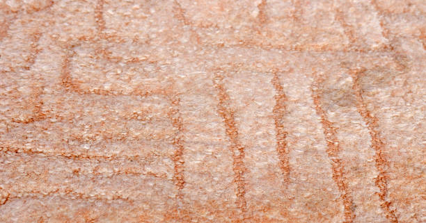 Close up of textured brownish stone surface with subtle patterns, ideal for backgrounds or natural themed projects.