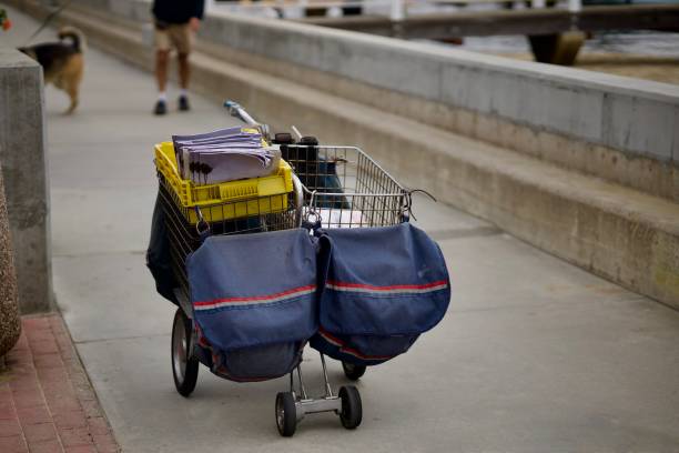 istock Mail carrier rolling cart filled with packages and letters 2175301362