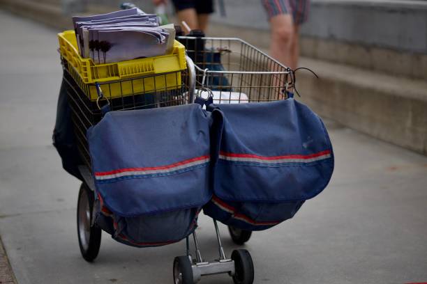 istock Mail carrier rolling cart filled with packages and letters 2175301363