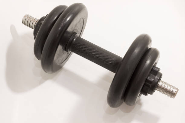 Black adjustable dumbbell on white background, perfect for home workouts and strength training.
