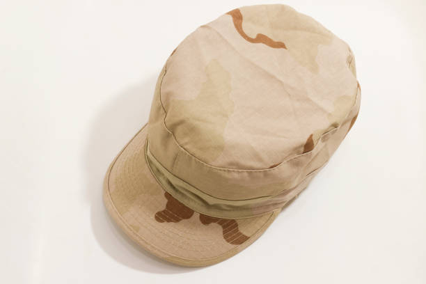 A beige military cap with desert camouflage pattern on white background, viewed from above.