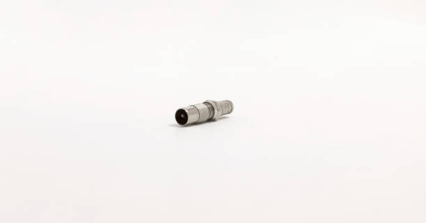 Close up of metallic connector on plain background, ideal for technology or hardware related themes.