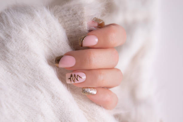 istock Female hand with golden manicure nails 2175305151