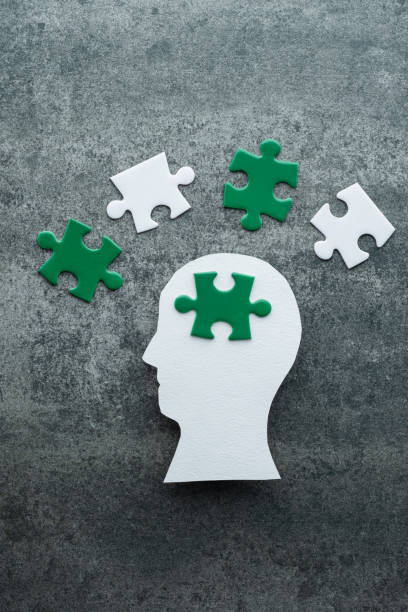 istock A human head silhouette with green and white puzzle pieces 2175306774